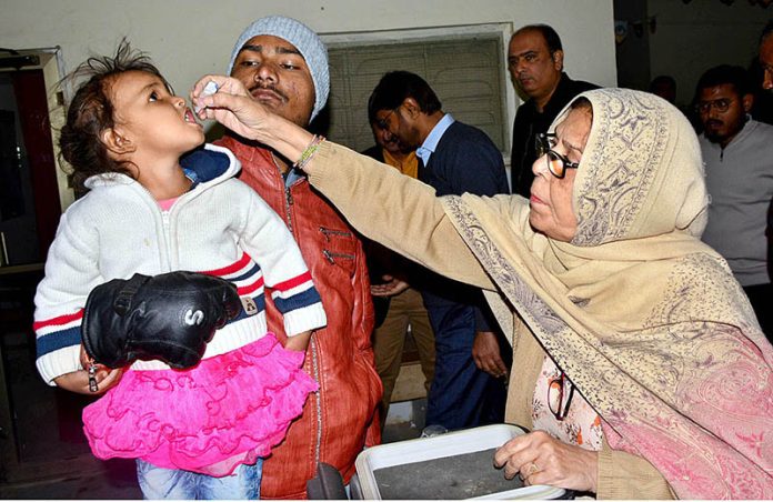 Woman health worker administering polio drops to child at Bhitai Hospital during the Polio Campaign in the city