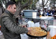 A vendor preparing and selling sweet dish (halwa) at his roadside setup
