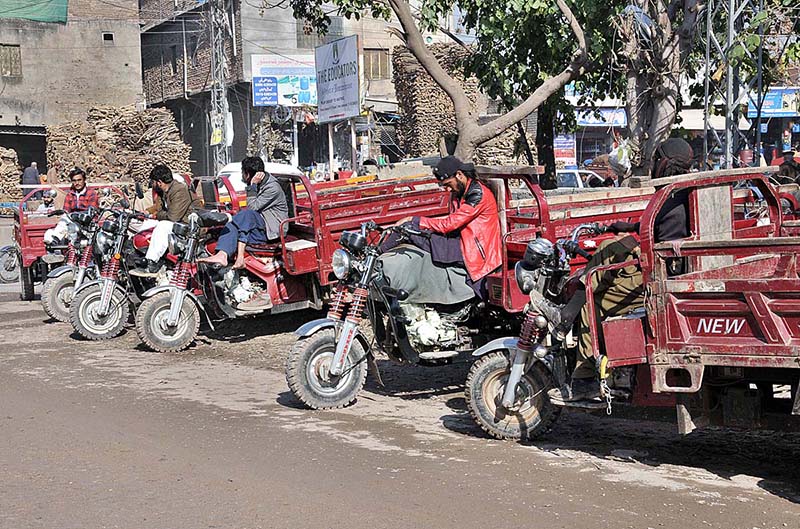 Drivers of loader rickshaws waiting for customers along Lehtrar Road to transport luggage from one place to another