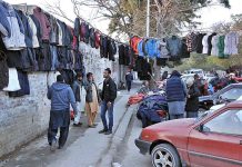 A large number of people busy in selecting and purchasing old warm clothes at Aabpara Market in Federal Capital