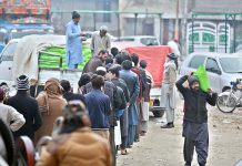 People queuing up to purchase subsidized flour from a delivery truck at Mukha Singh Estate neighborhood