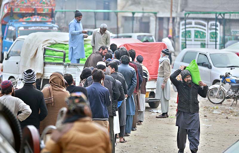 People queuing up to purchase subsidized flour from a delivery truck at Mukha Singh Estate neighborhood