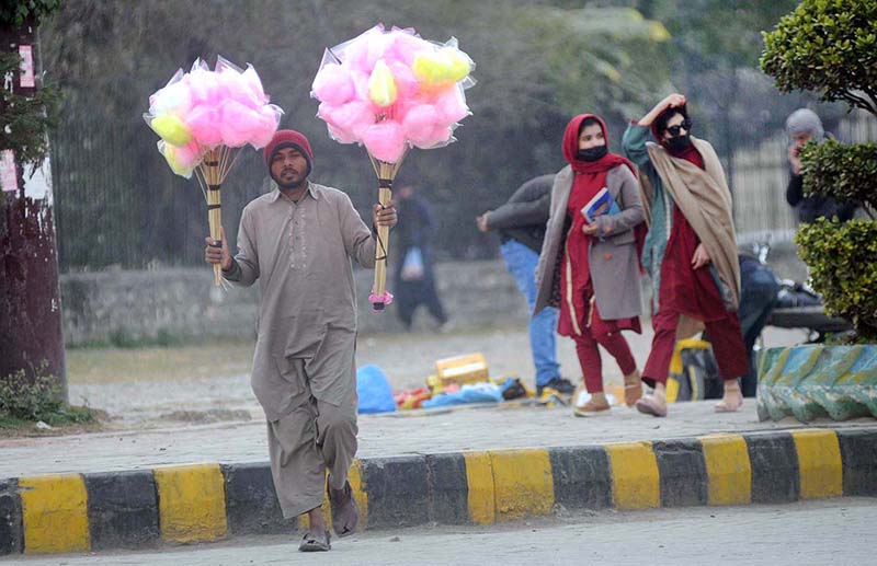 A street hawker displays cotton candy on the roadside to attract the customers.