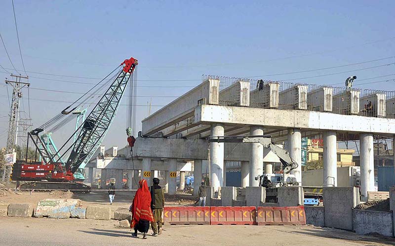 A view of construction work of 9th Avenue flyover at IJP Road during development work in the city