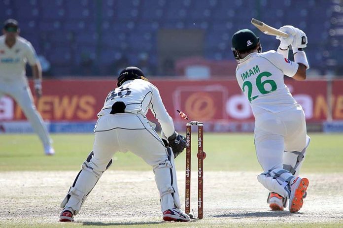 Imam-ul-Haq (R) being clean bowled by Ish Sodhi during the fifth and final day of the Second Cricket Test match between Pakistan and New Zealand at the National Stadium