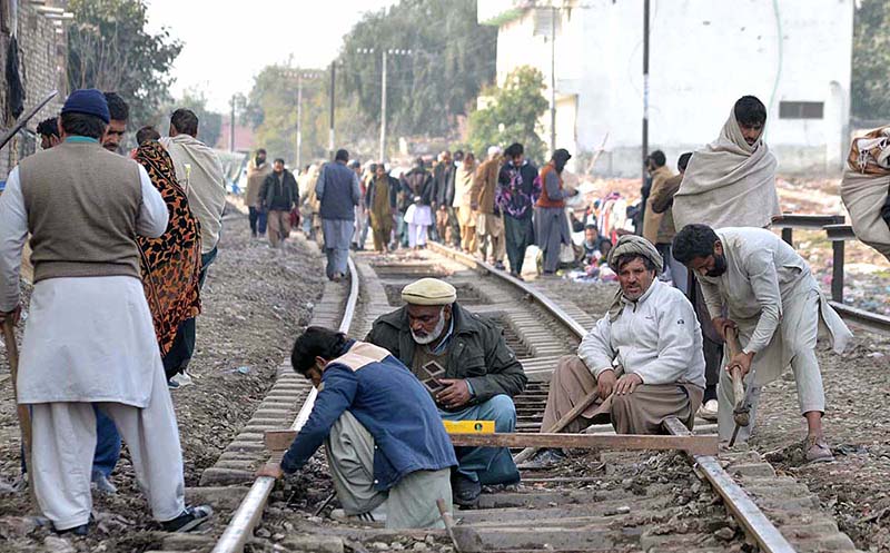 Labourers are busy in repairing railway tracks at Faqirabad area during maintenance work