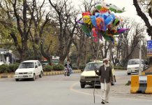 A vendor selling different kinds of balloons to attract customers at roadside.