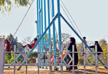 Children enjoying swing in a local park at G-9 in Federal Capital.