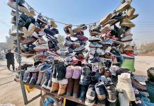 A vendor displaying second hand shoes to attract customers at Saidpur Road
