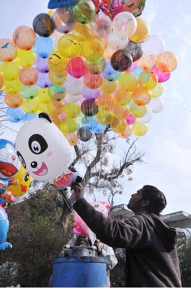 A street hawker displaying colorful balloons to sell at G-7 area