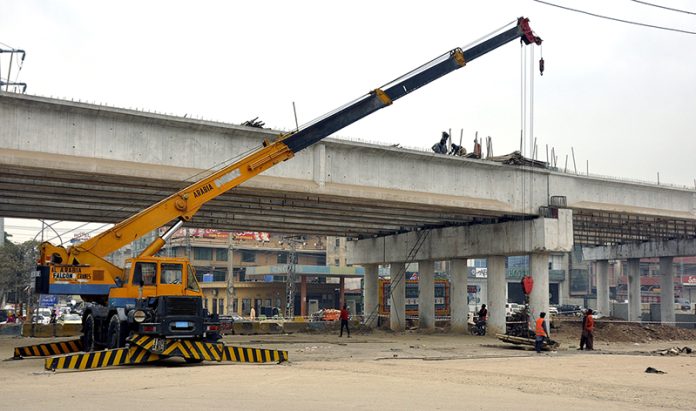 A view of construction work of 9th Avenue Flyover at IJP Road during development work in the city