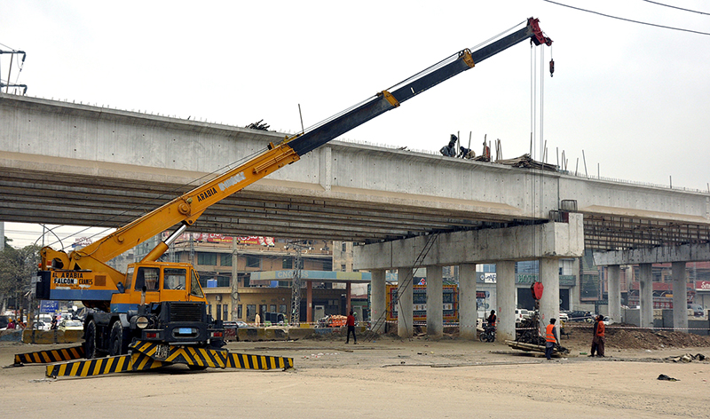 A view of construction work of 9th Avenue Flyover at IJP Road during development work in the city