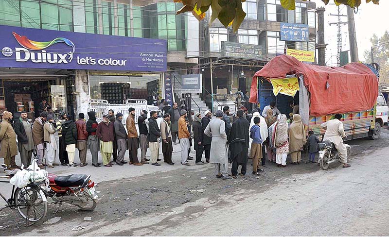 People waiting in queuing to purchase subsidized flour from a delivery truck