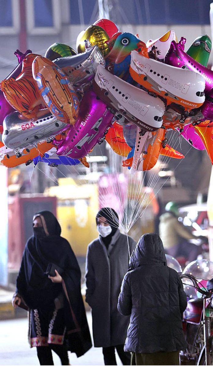 A street vendor displaying different kinds of balloons to attract customers