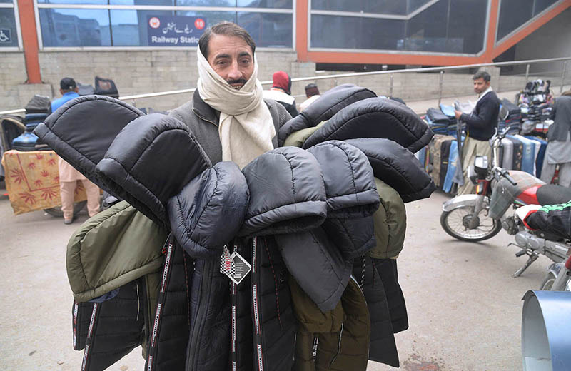 A Vendor displaying and selling jackets to attract the customers at his roadside setup in the Provincial Capital.