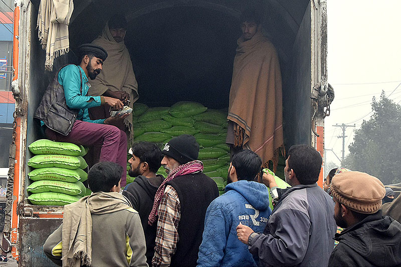 Many people standing in a queue for purchasing flour on subsidized rates