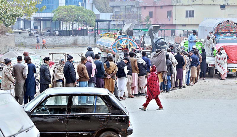 People queued to purchase subsidized floor from a delivery truck at Committee Chowk