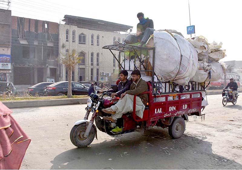 A loader rickshaw driver on his way loaded heavy cargo that may cause any accident