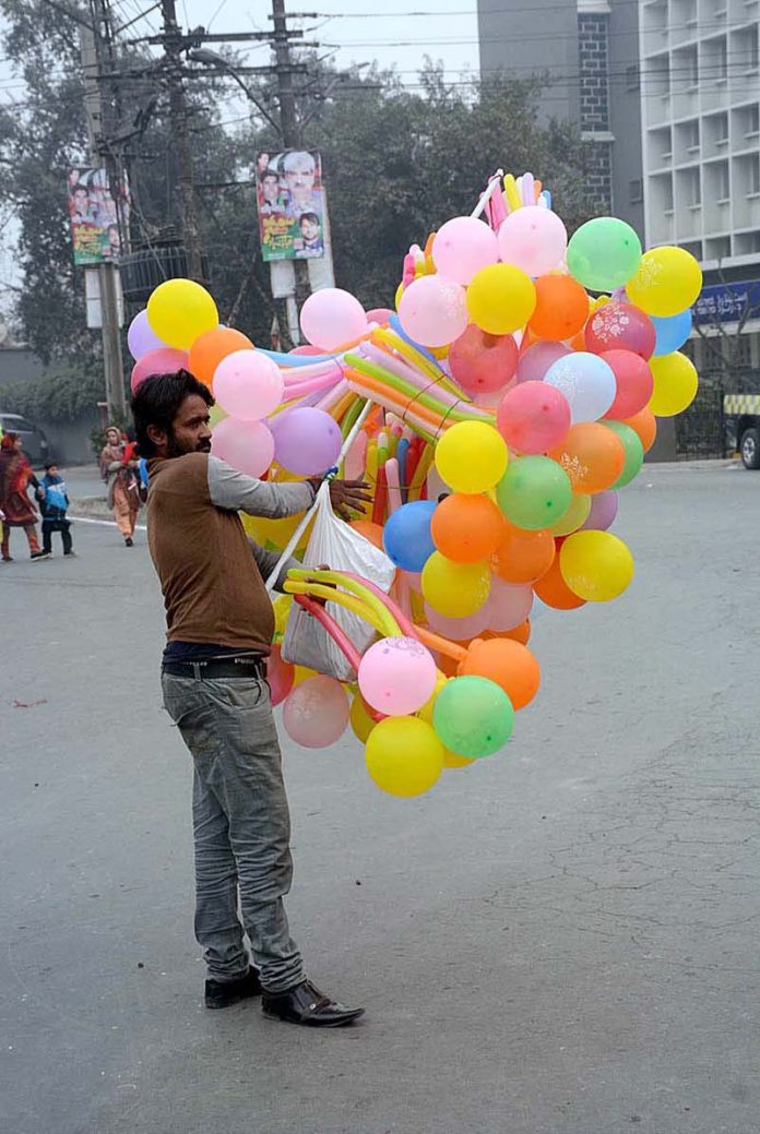 A vendor displaying colorful balloons to attract customers