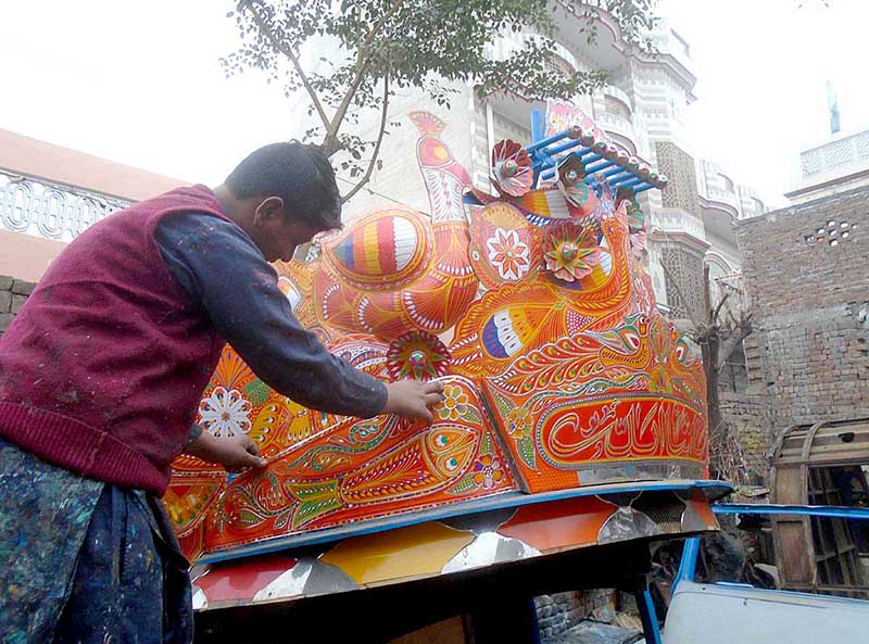A boy is decorating truck body at Sargodha Road
