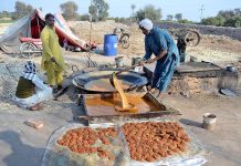 Farmer busy in making sweet items (GUR) at his workplace