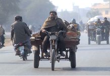 A man talking on call while riding tricycle rickshaw which may cause any mishap and needs the attention of concerned authorities