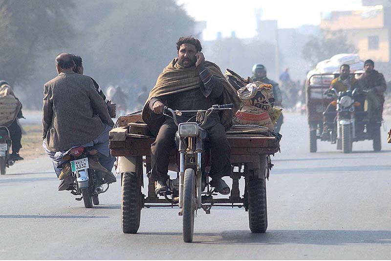 A man talking on call while riding tricycle rickshaw which may cause any mishap and needs the attention of concerned authorities