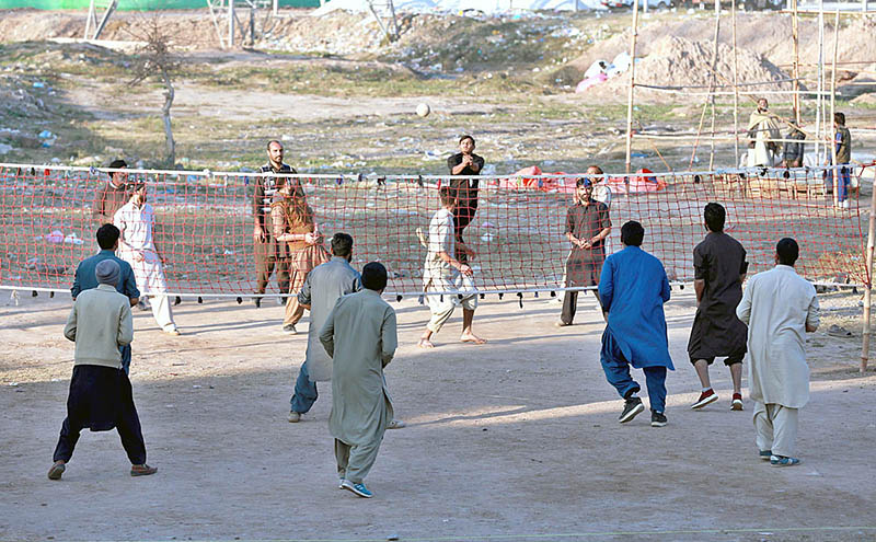 Youngsters playing volleyball match near Islamabad Expressway Road at Khanna Pul