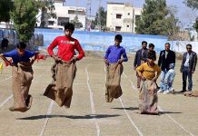 Students are participating in sack race during sports gala of Government Seth Kamaluddin High School at Wapda Ground in the city