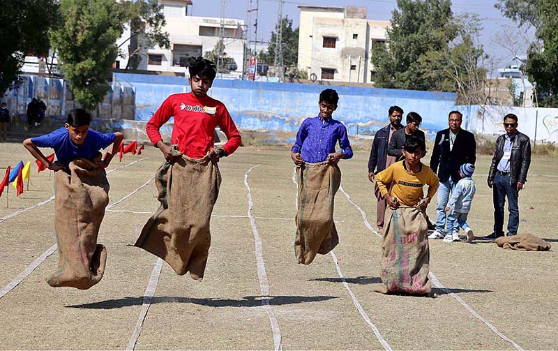 Students are participating in sack race during sports gala of Government Seth Kamaluddin High School at Wapda Ground in the city