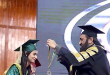 Punjab Governor Muhammad Baligh ur Rehman giving gold medals to the outstanding students during the 20th Convocation of Fatima Jinnah Women University for the graduates of 2022 held at Jinnah Convention Centre