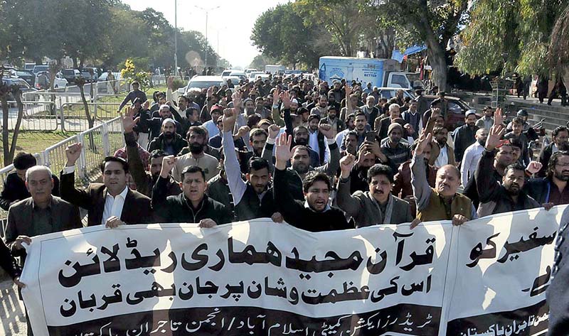 Traders are chanting slogans during a rally against the burning of Holy Quran in Sweden, at Aabpara Chowk