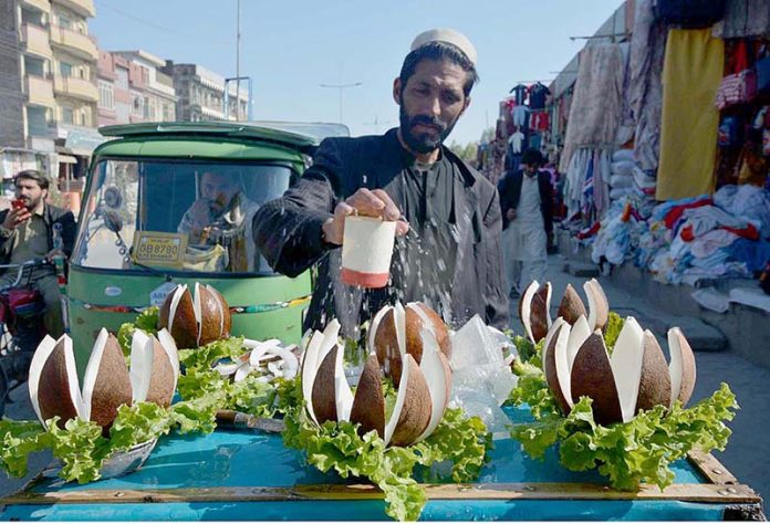 Vendor selling and displaying coconut to attract the customers at Faqirabad Road