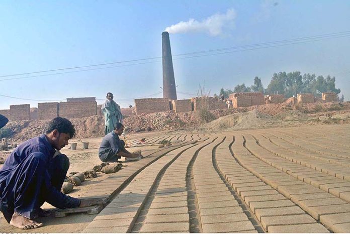 Labourers busy in preparing raw bricks at local kiln along Khushab Road