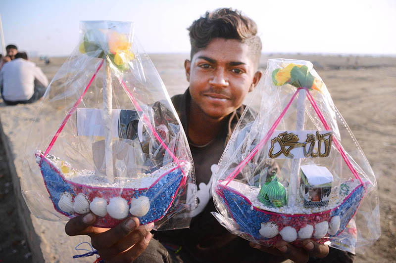 A vendor selling decoration pieces to earn money for livelihood at Sea view beach Clifton.