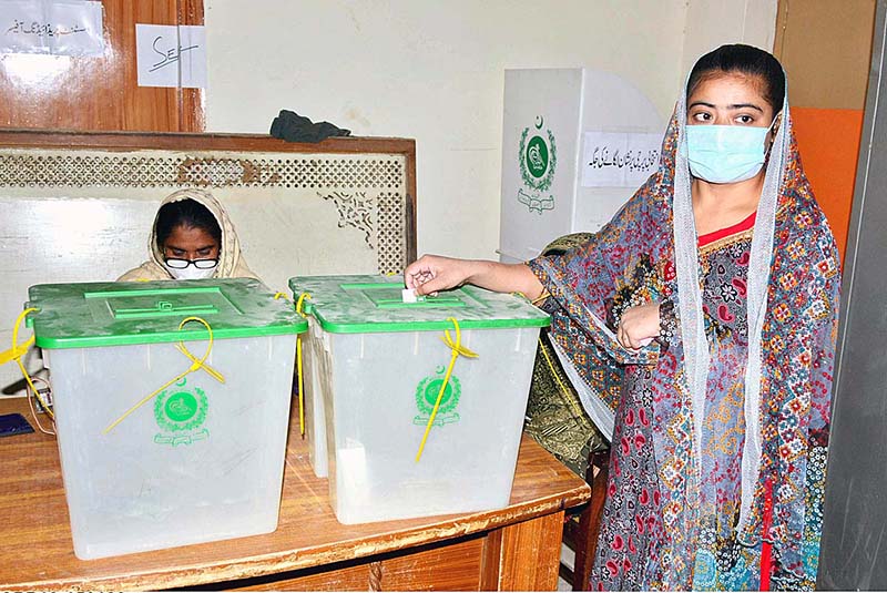 A woman casts her vote in the polling station during Local Government Elections
