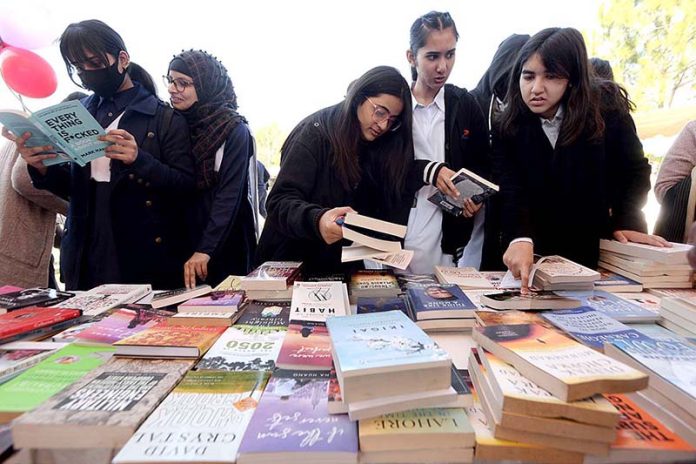 Students are taking keen interest in books at a stall during the 4 days Capital Book Fair-2023 at Arts and Craft Village