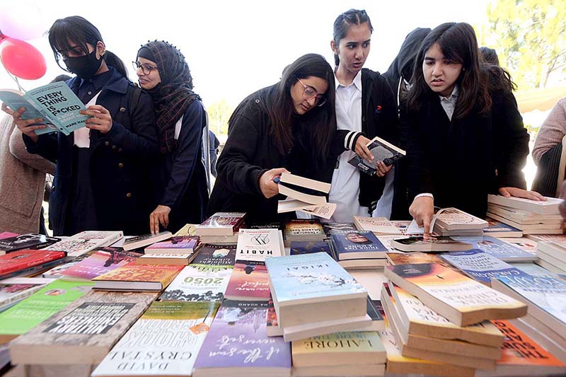 Students are taking keen interest in books at a stall during the 4 days Capital Book Fair-2023 at Arts and Craft Village