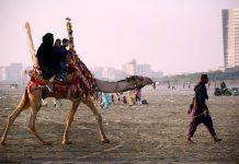 Family enjoying camel ride at Sea view beach Clifton.