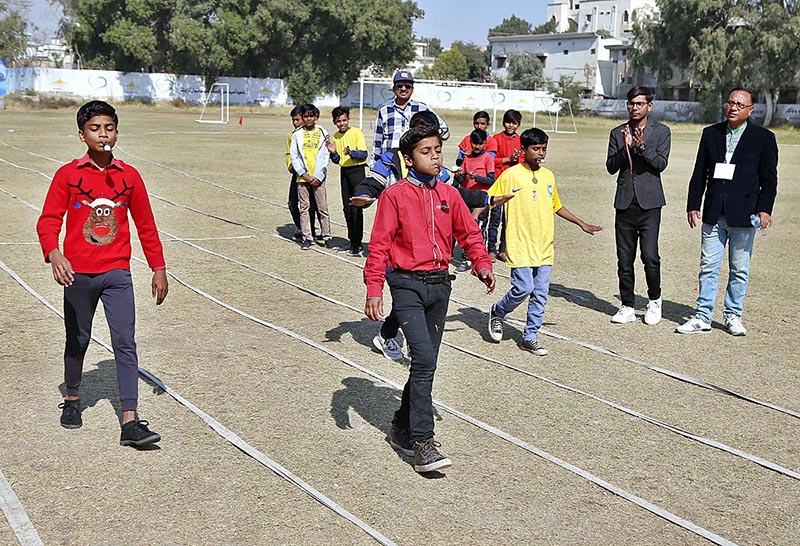 Students are participating in sack race during sports gala of Government Seth Kamaluddin High School at Wapda Ground in the city