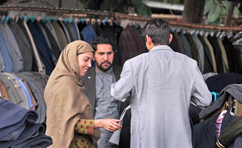 A family choosing used coat from a stall at G-9 markaz.