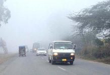 Vehicles on the way at Khushab Road during thick fog that engulfs the city