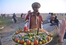 Old man selling Chana chat to earn money for livelihood at Sea view Clifton