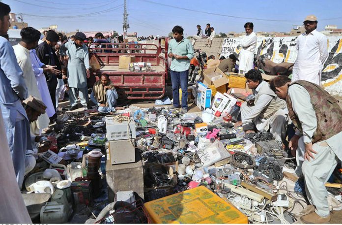 Customers are showing their interest to purchase old and used electric item in reasonable price by the vendor at Friday bazaar Kalai Mori Chowk