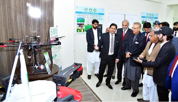 President Dr. Arif Alvi being briefed about Precision Agriculture Technologies, at the Pir Mehr Ali Shah Arid Agriculture University