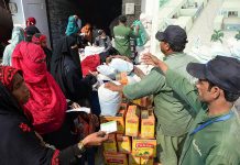Workers of Saylani Welfare Trust distributing Ration Bags among the deserving women at Latifabad.