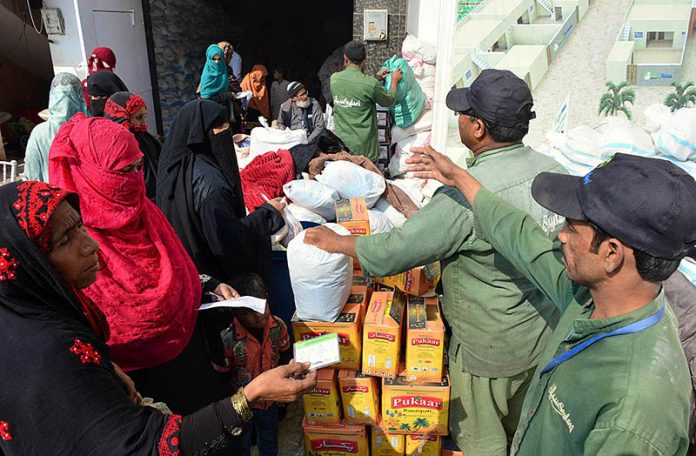 Workers of Saylani Welfare Trust distributing Ration Bags among the deserving women at Latifabad.