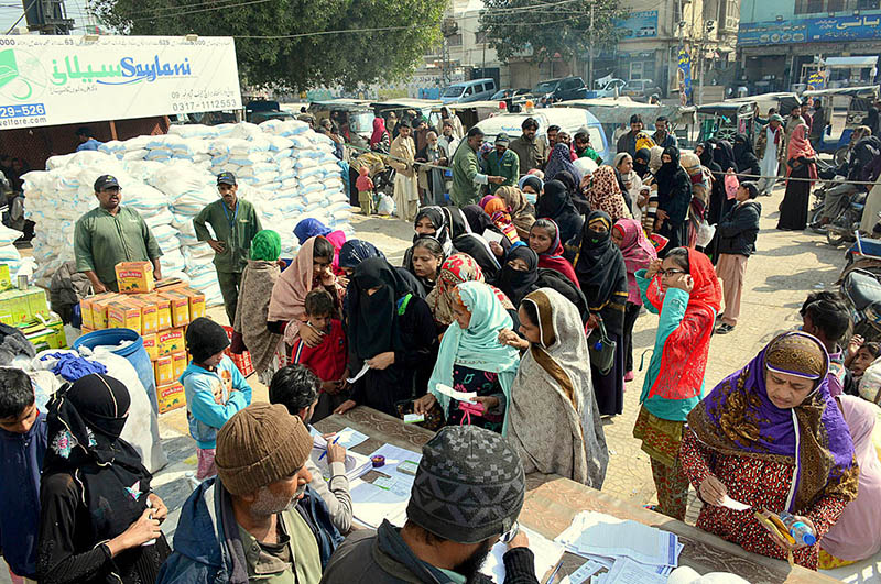 Workers of Saylani Welfare Trust distributing Ration Bags among the deserving women at Latifabad.