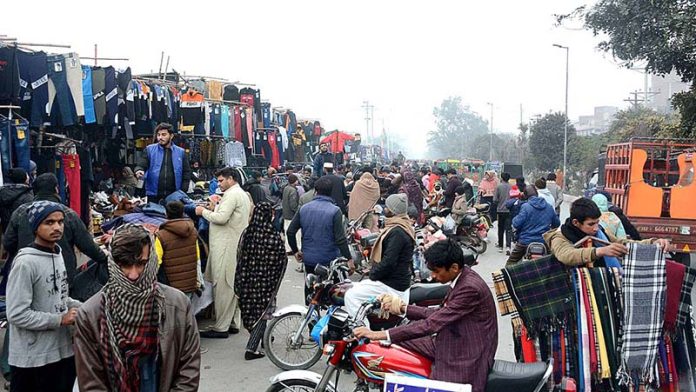 People selecting and purchasing the second hand warm clothes at Landa Bazar.