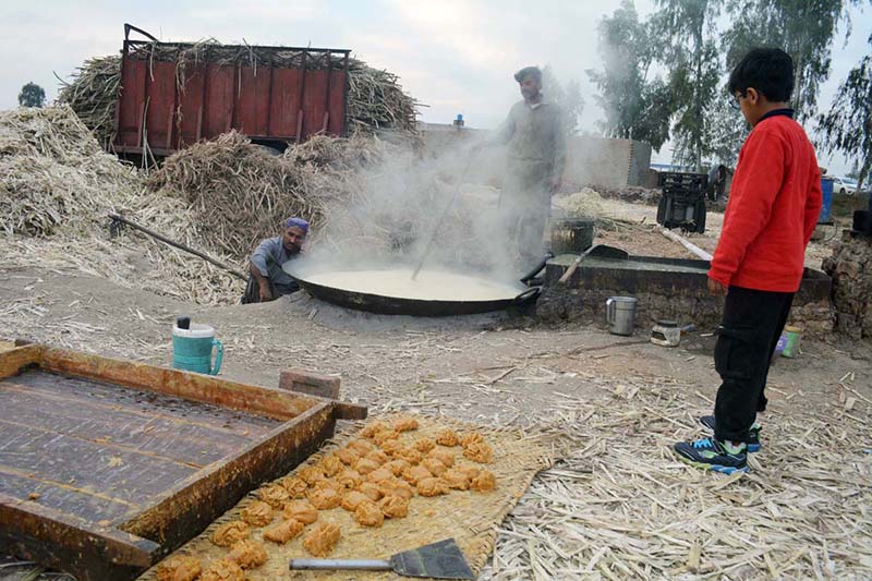 A vendor selling traditional sweet item gurr at Khushab road